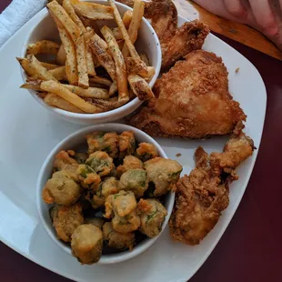 Fried chicken with a side of fries and fried okra.