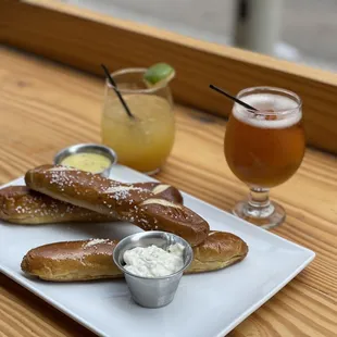 Pretzel appetizer with Dijon mustard and whipped feta. Piña punch and earl grey mimosa