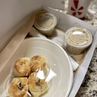 Brunch meal: bottled water or coffee, biscuits and gravy. Not pictured is a chocolate chunk butterscotch cookie.