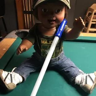 a little boy playing pool