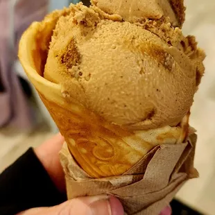 Vegan gingerbread ice cream in waffle cone