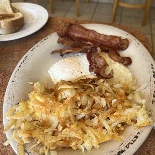 a plate of hash browns and bacon