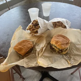 Double and single cheeseburger with fries and onion straws.
