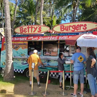 people standing in front of a food truck