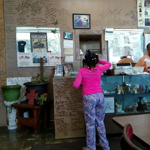 a woman standing in front of a counter