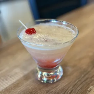 a drink with a cherry garnish