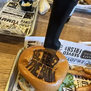 a burger with a knife sticking out of it