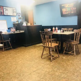 a dining area with tables and chairs