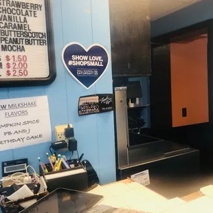 a counter with a keyboard and a sign