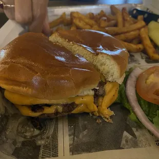 Lame burger and skimpy potion of fries in the background. The fries were good and hot.