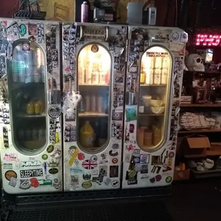 a refrigerator covered in stickers