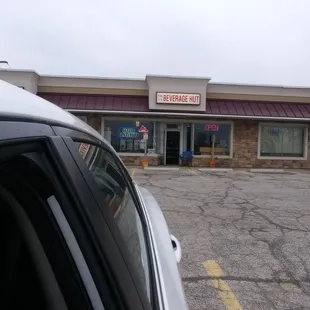 a car parked in front of a beverage hut