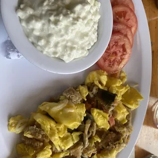 a plate of food with a bowl of yogurt