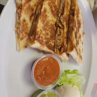 Chicken quesadillas with a house made hot sauce.