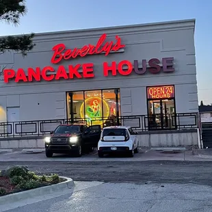 two cars parked in front of the restaurant