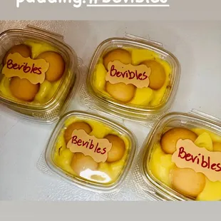 four plastic containers filled with bananas