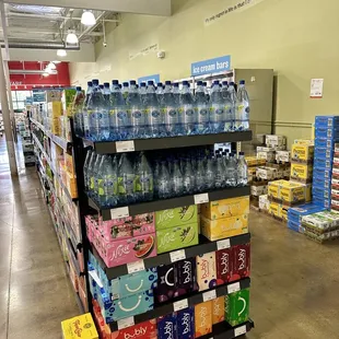 a display of bottled water in a grocery store