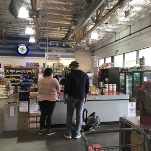 a man and a woman in a grocery store