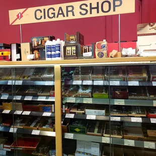 a man standing in front of a cigar shop