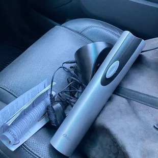 a hair dryer and other items in the back seat of a car