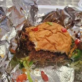 The El Toro. Chimichrri, slow roasted brisket, jalapeños, Jack cheese, and red onions on fresh Cuban bread.