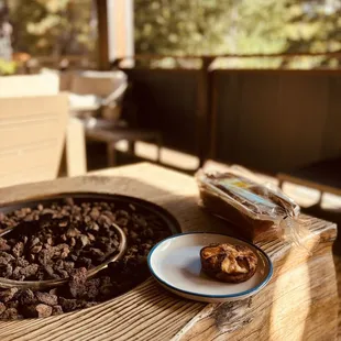 a bowl of chocolate and a plate of nuts