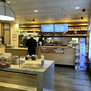a bakery counter with a man standing at the counter