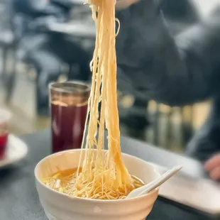Friend eating the HK Style Wonton Noodle Soup $13.50