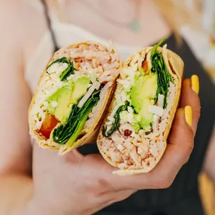 a woman holding a burrito