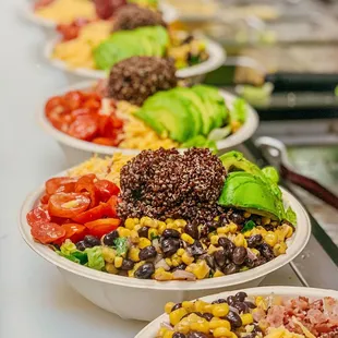 a line of bowls of food