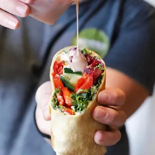 a person holding a burrito