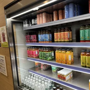 Cooler filled with fresh juices and other beverages.