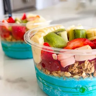 two bowls of fruit and yogurt