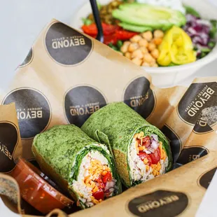 a burrito and a bowl of salad