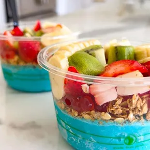 two bowls of fruit and yogurt