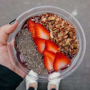a person holding a bowl of fruit