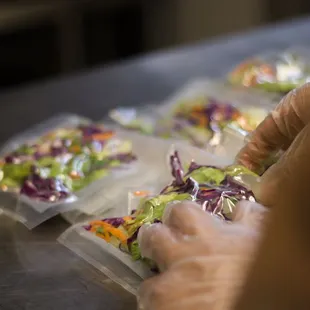 a person preparing food in plastic bags