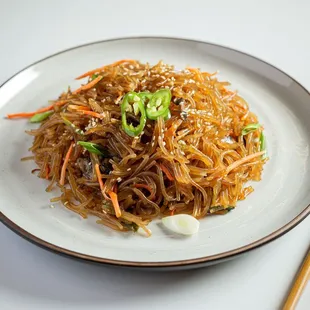 Japchae

a sweet and savory dish of stir-fried glass noodles and vegetables that is popular in Korean cuisine