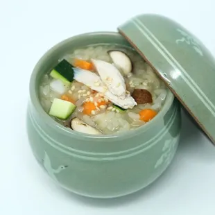 a bowl of soup with chicken and vegetables