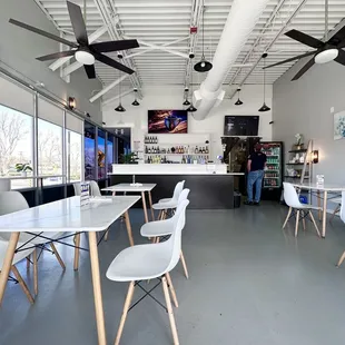 a restaurant with white tables and white chairs