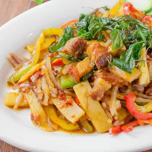 a plate of noodles with meat and vegetables