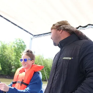 Albert our swamp tour guide letting my son drive for a minute