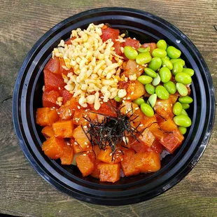 a bowl of food on a wooden table