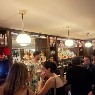 a group of people sitting at a bar