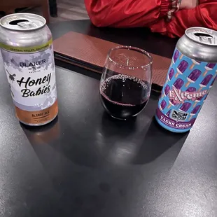 a glass of wine and a can of beer