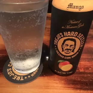 a glass of water and a can of hard cid