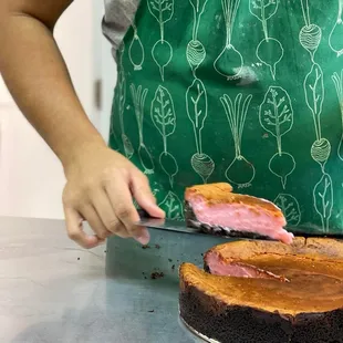 a person cutting a cake