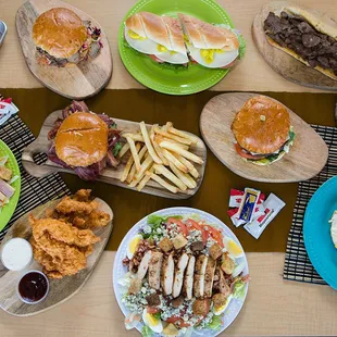 a table full of burgers and fries
