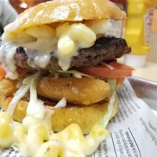 The double mac n' cheese burger, medium rare, on a brioche bun.