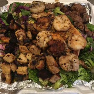 The BGR Ultimate Grill Mix - Chicken, shrimp, salmon, and steak atop your choice of veggies and rice. More than enough for two!